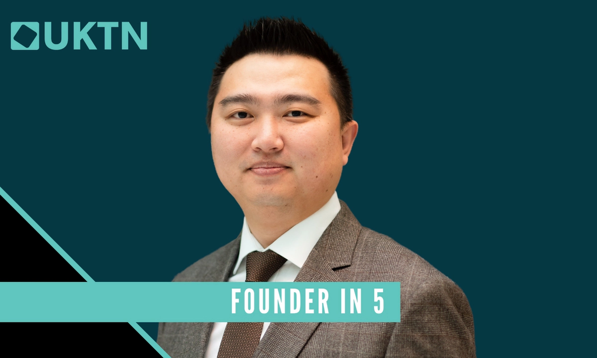 A picture of Transreport founder Jay Shen wearing a grey suit, in front of a dark turquoise and black plain background. The top left of the image has the UKTN logo in light turquoise colour, and a light turquoise banner spans the image at the bottom reading 'Founder in 5'.