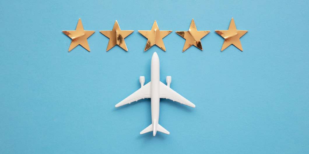 A model white plane on a blue background with 5 gold stars above it.