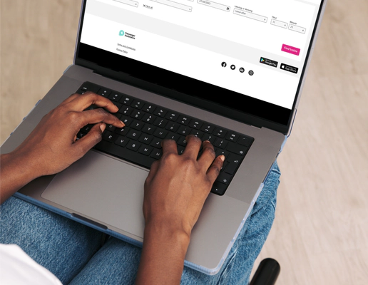 A close-up of a person using a laptop computer resting on their lap.