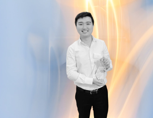 Jay Shen, an asian man with short black hair, and CEO of Transreport, smiling and holding an award.