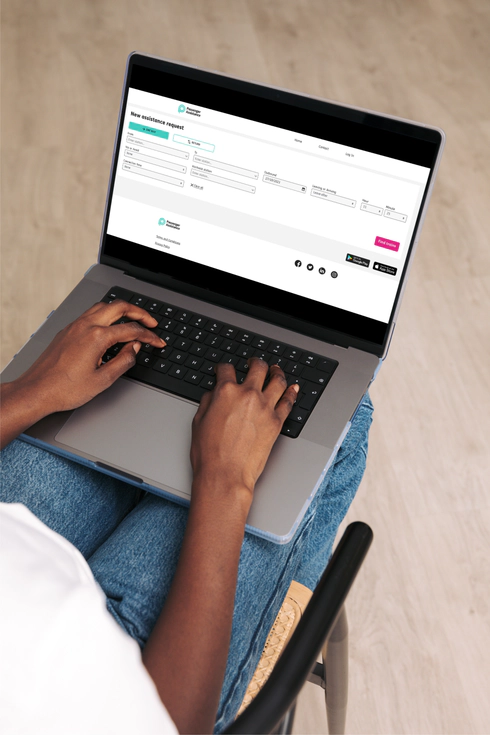 A close-up of a person using a laptop computer resting on their lap.