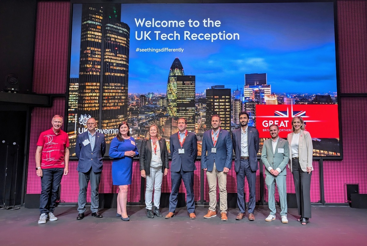 Waleed Ahmed standing with the delegates of the UK tech ecosystem in front of the Welcome to the UK Tech Reception sign at the SelectUSA Investment Summit.