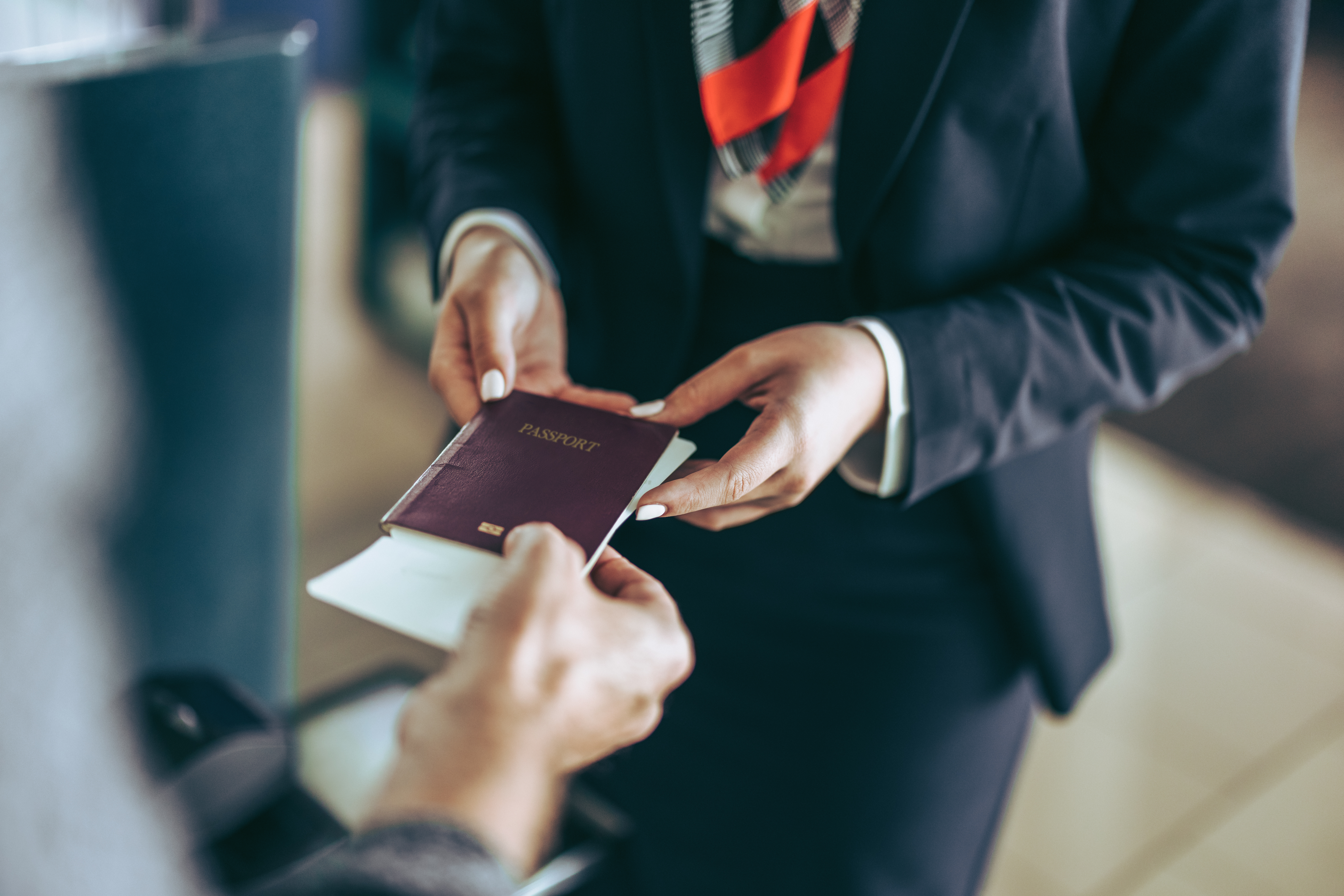 Photo of a staff member being handed a passport.