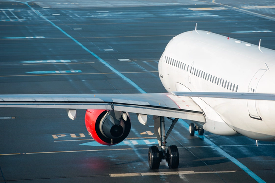 Photo of a white plane on a runway.