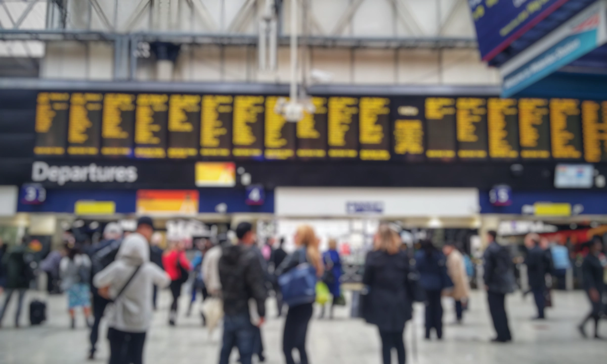 Blurred image of crowded passengers in Waterloo looking at the timetable. Blurred image of crowded passengers in Waterloo looking at the timetable.